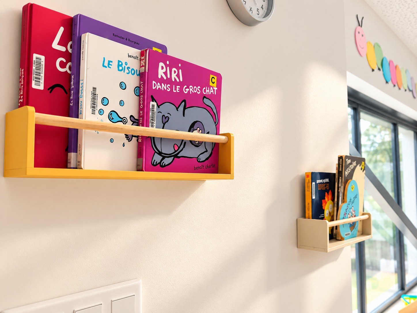 Livres pour enfants présentés sur des étagères en bois dans la micro-crèche